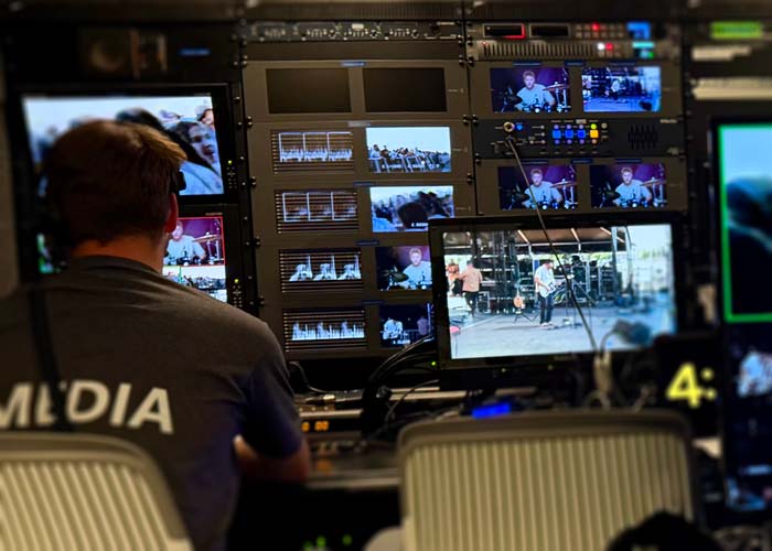 Control room broadcast engineer monitoring multiple camera feeds