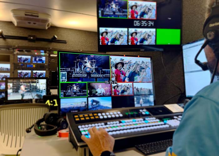 Director and techincal director in Professional control room with broadcast switcher and monitors